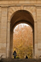 Arab woman enters monumental gate