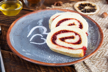 Swiss roll with strawberry jam. Jelly roll with decoration