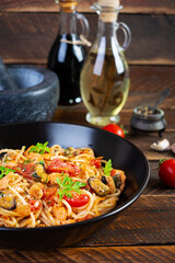 Seafood pasta with clams, salmon and tomatoes. Spaghetti with seafood cocktail