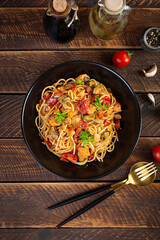 Seafood pasta with clams, salmon and tomatoes. Spaghetti with seafood cocktail