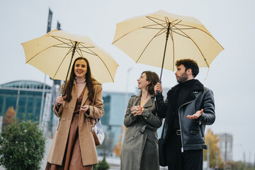 Cheerful trio with umbrellas enjoying good company despite the rain, showcasing friendship and...