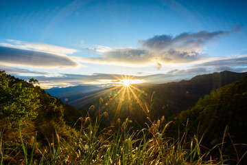 Fototapeta na wymiar Sun shining through the mountains