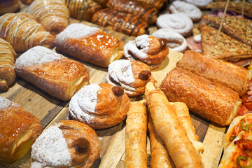 An array of freshly baked pastries on a wooden board.