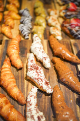 Variety of croissants and chocolate-covered pastries.