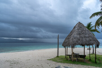 San Blas caribic island shelter hut on beautiful beach with dramatic windy weather in background at low light