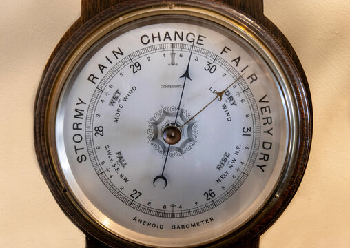 Unbranded antique round dial type aneroid barometer in a wooden frame,	

