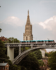 view of tram and munster cathedral in bern switzerland