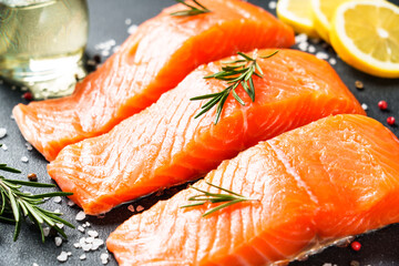 Salmon fillet, raw fresh fish with rosemary and spices. Macro image.