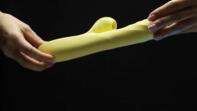 An adult toy. The girl is holding a sex shop toy Sex toy clitoral vibrator