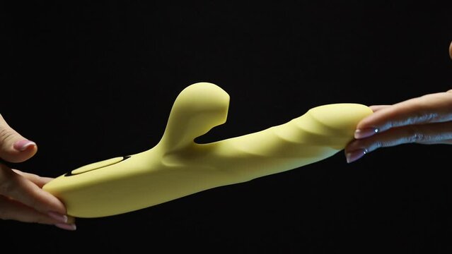 An adult toy. The girl is holding a sex shop toy Sex toy clitoral vibrator