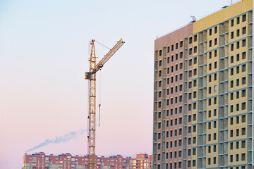 Fototapeta na wymiar construction crane near a building under construction