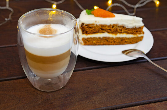Carrot sponge cake with cream and walnuts and Cappuccino coffee