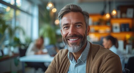 A stylishly bearded man exudes warm confidence as he smiles charmingly at the camera inside a cozy restaurant, his glasses adding a touch of sophistication against the textured wall backdrop - obrazy, fototapety, plakaty