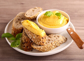 Homemade, organic red lentil spread over brown seed bread