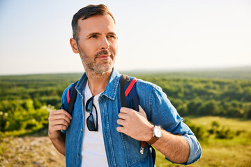 Handsome mid adult man hiking.