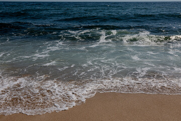 Fototapeta na wymiar Sandy beach, waves and sea
