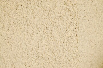 Beige Betonwand mit Muster als Hintergrund