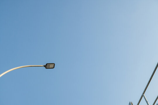 Light street lamp with blue sky background. The photo is suitable to use for industry background photography, power plant poster and maintenance content media.