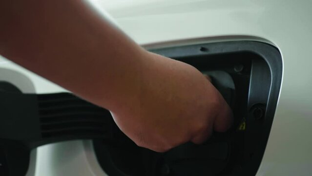hand unplug power cable supply to charging electric car at home