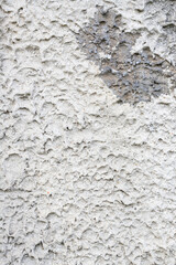 Rough gray plaster on the outer wall of the palace.