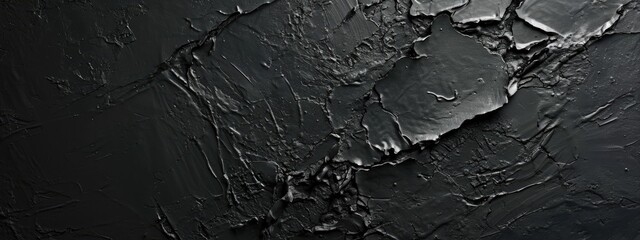 Fototapeta premium A dark backdrop featuring the rugged texture of stone and black grunge wall.