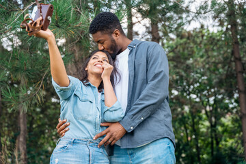 A handsome man and beautiful woman hugging each other, felling in love and spending time in the park  Time together