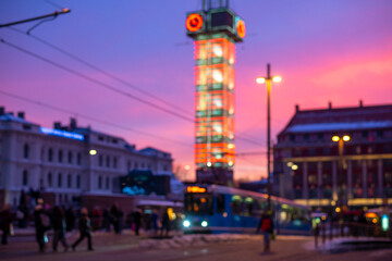 Blured picture of Oslo city centre. Urban Elegance: Glass Clock Tower and public transportation in...