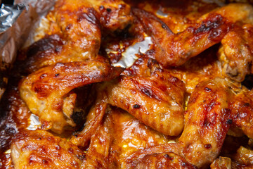 Chicken wings baked in soy sauce and garlic marinade with a crispy crust close-up