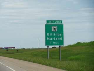 Road sign with distance and directions to Billings and Marland exit in Oklahoma USA.