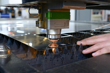 Laser machine cutting metal sheet, sparks coming