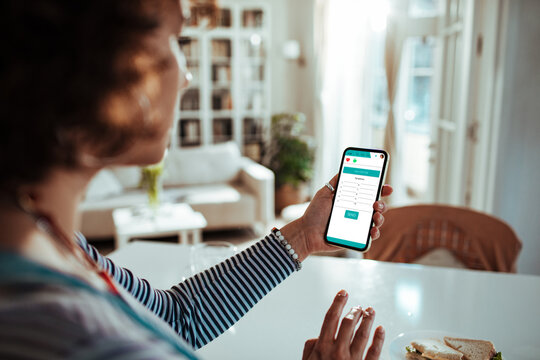 Woman using a mobile healthcare app for online doctor consultation at home