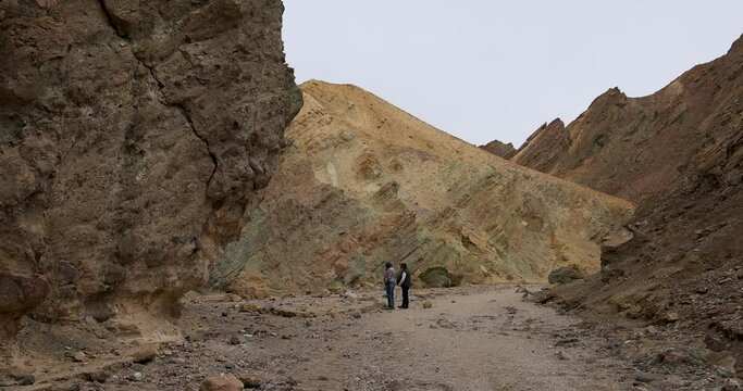 Death Valley women hiking narrow slot canyon. Largest national park in contiguous USA. 282 feet below sea level. Mojave Desert bordering Great Basin Desert. Ecological geology. 