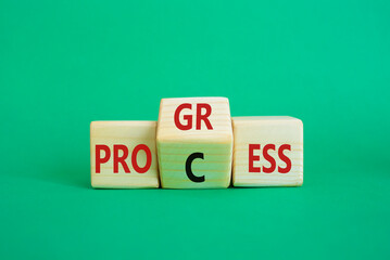 Process and Progress symbol. Wooden cubes with words Process and Progress. Beautiful green background. Business and Process and Progress concept. Copy space