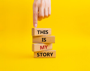 This is my Story symbol. Wooden blocks with words This is my Story. Businessman hand. Beautiful yellow background. Business and This is my Story concept. Copy space.