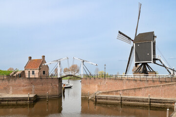 Drawbridge and mill at the harbor of the medieval fortified town of Heusden in the Netherlands.