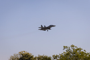 military fighter aircraft coming for landing at airfield at day
