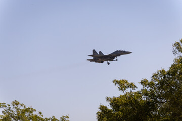 military fighter aircraft coming for landing at airfield at day