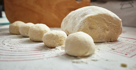 The kneaded dough lies on the table ready for cooking