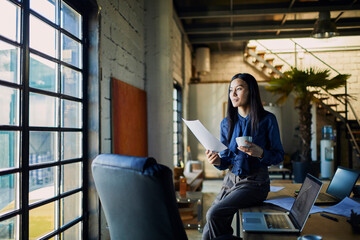 Young woman with paperwork document in modern office