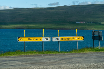 Iceland road signs giving directions to various towns (Reykjavik, Holmavik)