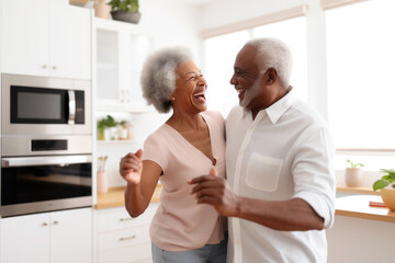 African multiracial married senior mature couple dancing in the kitchen