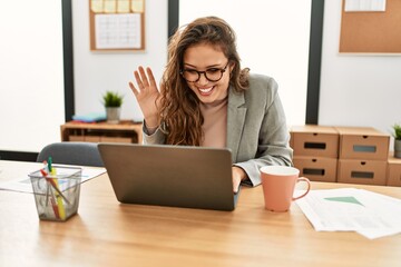 Young beautiful hispanic woman business worker having video call at office