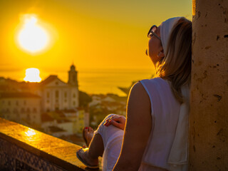 Woman sitting at Santa Luzia viewpoint in Lisbon
