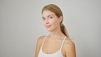 Fototapeta premium Young blonde woman smiling confident standing over isolated white background