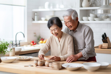 Obraz na płótnie Canvas Asian married senior mature couple baking in the kitchen