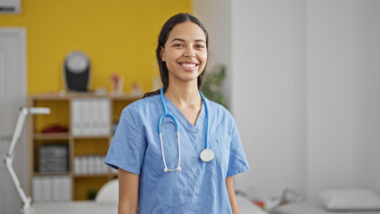 African american woman doctor smiling confident wearing stethoscope at clinic