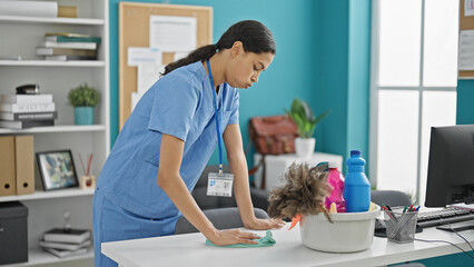 African american woman professional cleaner cleaning table tired at the office