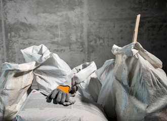 Stucco and construction garbage bags after indoor repair, rough dirty works.