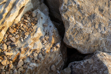 Large rocks and a gap between them on the sea coast. Background big stones