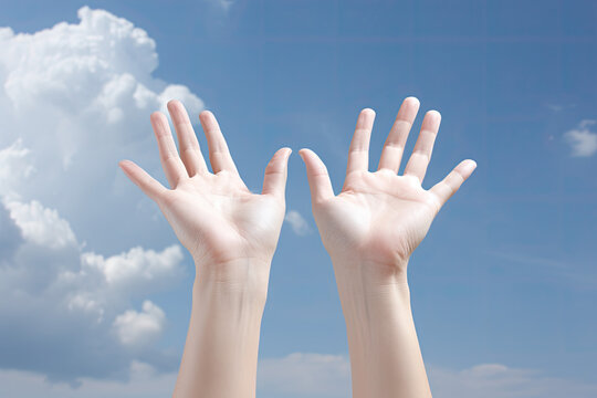 Close up of human hands against blue sky with white clouds background